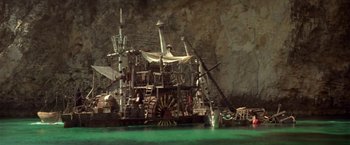 Movie still from “Popeye” (1980), directed by Robert Altman – A pirate ship in the middle of the water; Extreme Wide shot, Low angle