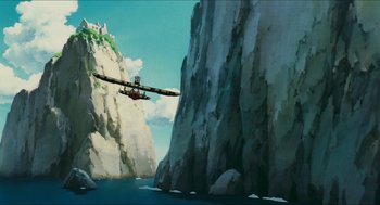 Movie still from “Porco Rosso” (1992), directed by Hayao Miyazaki – An airplane flying over a body of water near a cliff; Extreme Wide shot, Low angle