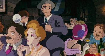 Movie still from “Porco Rosso” (1992), directed by Hayao Miyazaki – A group of people sitting in a room; Medium shot, Over the shoulder angle