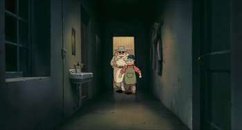 Movie still from “Porco Rosso” (1992), directed by Hayao Miyazaki – An old man and a young boy are in a dark hallway; Wide shot, High angle