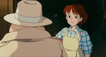 Movie still from “Porco Rosso” (1992), directed by Hayao Miyazaki – A boy standing next to a man in a hat; Medium shot, Over the shoulder angle
