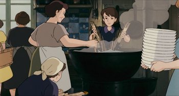 Movie still from “Porco Rosso” (1992), directed by Hayao Miyazaki – An illustration of a woman cooking in a wok; Medium shot, High angle