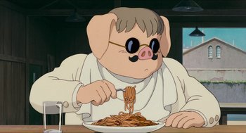 Movie still from “Porco Rosso” (1992), directed by Hayao Miyazaki – A cartoon of a pig eating spaghetti from a plate; Medium shot, Low angle