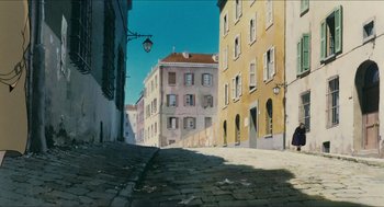 Movie still from “Porco Rosso” (1992), directed by Hayao Miyazaki – A painting of an old european city street; Extreme Wide shot, Low angle
