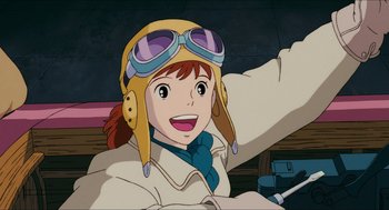 Movie still from “Porco Rosso” (1992), directed by Hayao Miyazaki – A woman wearing a pilot's hat and a scarf; Close Up shot, Low angle
