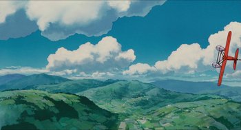 Movie still from “Porco Rosso” (1992), directed by Hayao Miyazaki – An oil painting of a green valley and a blue sky with white clouds; Extreme Wide shot, Low angle