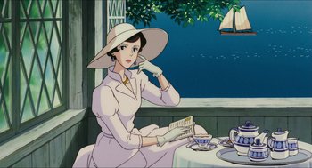 Movie still from “Porco Rosso” (1992), directed by Hayao Miyazaki – An animated woman sitting at a table holding a book; Medium shot, Low angle