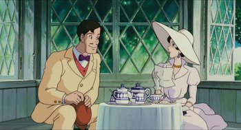 Movie still from “Porco Rosso” (1992), directed by Hayao Miyazaki – An animated scene of a man and woman sitting at a table; Medium shot, Over the shoulder angle