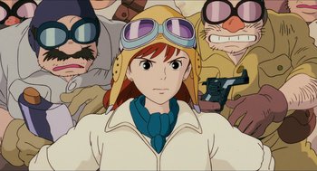 Movie still from “Porco Rosso” (1992), directed by Hayao Miyazaki – A woman in a pilot's outfit with a group of people behind her; Close Up shot, Low angle