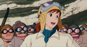 Movie still from “Porco Rosso” (1992), directed by Hayao Miyazaki – A woman with a helmet on her head; Close Up shot, Low angle
