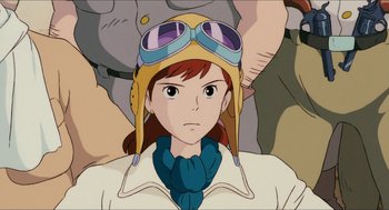 Movie still from “Porco Rosso” (1992), directed by Hayao Miyazaki – An animated woman wearing a pilot's helmet; Close Up shot, Low angle