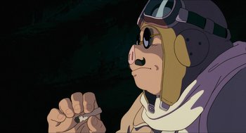 Movie still from “Porco Rosso” (1992), directed by Hayao Miyazaki – An animated pig is holding a cigarette in his hand; Close Up shot, Low angle