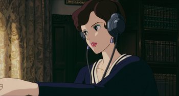 Movie still from “Porco Rosso” (1992), directed by Hayao Miyazaki – A woman wearing headphones and looking at the camera; Close Up shot, High angle