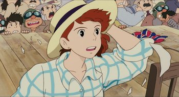 Movie still from “Porco Rosso” (1992), directed by Hayao Miyazaki – A woman in a hat and a plaid shirt; Close Up shot, High angle