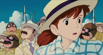 Movie still from “Porco Rosso” (1992), directed by Hayao Miyazaki – A woman in a hat and a man in a suit; Close Up shot, Low angle