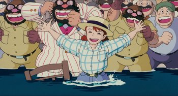 Movie still from “Porco Rosso” (1992), directed by Hayao Miyazaki – A man in a hat is standing in the water; Medium shot, High angle