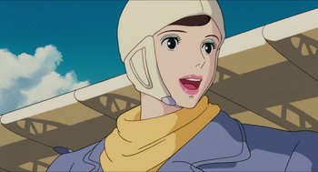 Movie still from “Porco Rosso” (1992), directed by Hayao Miyazaki – An animation of a woman wearing a helmet; Close Up shot, Low angle