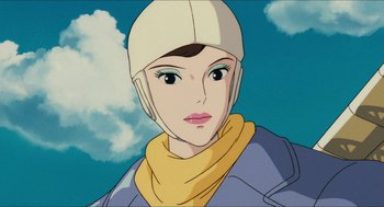 Movie still from “Porco Rosso” (1992), directed by Hayao Miyazaki – An animated picture of a woman wearing a helmet; Close Up shot, Low angle