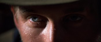 Movie still from “Posse” (1993), directed by Mario Van Peebles – View of a person's eyes with water droplets on them; Extreme Close Up shot, Low angle