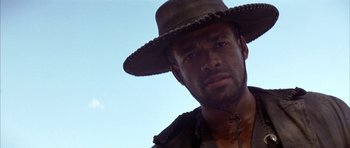 Movie still from “Posse” (1993), directed by Mario Van Peebles – A person wearing a cowboy hat; Close Up shot, Low angle