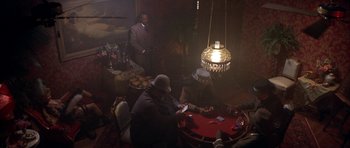 Movie still from “Posse” (1993), directed by Mario Van Peebles – A group of men playing a game of poker; Wide shot, High angle