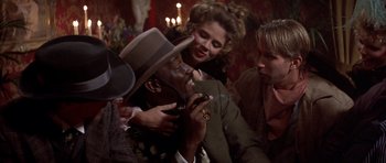 Movie still from “Posse” (1993), directed by Mario Van Peebles – A man and woman looking at a cell phone; Medium shot, Over the shoulder angle