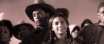 Movie still from “Posse” (1993), directed by Mario Van Peebles – A man and a woman wearing cowboy hats; Close Up shot, Low angle