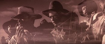 Movie still from “Posse” (1993), directed by Mario Van Peebles – A man wearing a hat and smoking a cigarette in front of a building; Close Up shot, Low angle