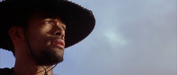 Movie still from “Posse” (1993), directed by Mario Van Peebles – A person wearing a hat; Close Up shot, Low angle