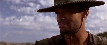 Movie still from “Posse” (1993), directed by Mario Van Peebles – A person wearing a hat; Close Up shot, Low angle