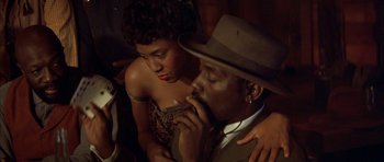 Movie still from “Posse” (1993), directed by Mario Van Peebles – A man and a woman sitting next to each other; Close Up shot, Low angle