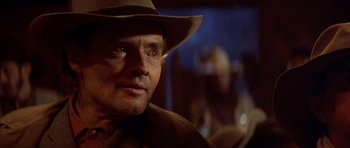 Movie still from “Posse” (1993), directed by Mario Van Peebles – A person wearing a hat; Close Up shot, Over the shoulder angle