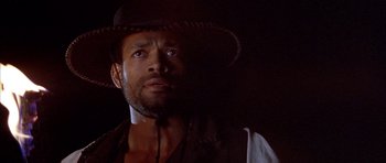 Movie still from “Posse” (1993), directed by Mario Van Peebles – A person wearing a hat; Close Up shot, Low angle