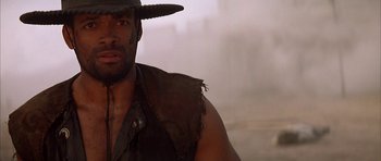 Movie still from “Posse” (1993), directed by Mario Van Peebles – A person wearing a hat; Close Up shot, Low angle