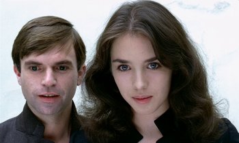 A man and a woman standing next to each other