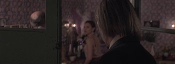 Movie still from “Post Mortem” (2010), directed by Pablo Larraín – A man and a woman are looking in a mirror; Close Up shot, Over the shoulder angle