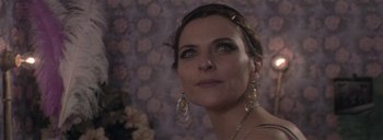 Movie still from “Post Mortem” (2010), directed by Pablo Larraín – A person wearing earrings; Close Up shot, Over the shoulder angle