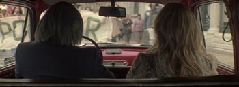 Movie still from “Post Mortem” (2010), directed by Pablo Larraín – Two people in a car looking out of the window; Medium shot, Over the shoulder angle