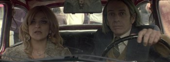 Movie still from “Post Mortem” (2010), directed by Pablo Larraín – Two women sitting in the back seat of a car; Close Up shot, Low angle