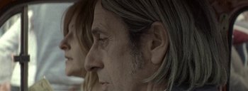Movie still from “Post Mortem” (2010), directed by Pablo Larraín – An older man with long hair is looking into the distance; Close Up shot, Low angle