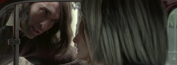 Movie still from “Post Mortem” (2010), directed by Pablo Larraín – Two women sitting close together in front of each other; Close Up shot, Over the shoulder angle