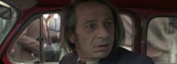 Movie still from “Post Mortem” (2010), directed by Pablo Larraín – A person with long hair; Close Up shot, Over the shoulder angle