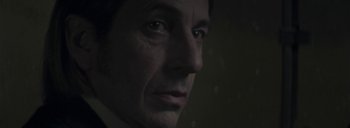 Movie still from “Post Mortem” (2010), directed by Pablo Larraín – A man's face in the dark; Extreme Close Up shot, Low angle