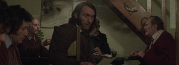 Movie still from “Post Mortem” (2010), directed by Pablo Larraín – A man sitting at a table with papers in front of him; Close Up shot, Over the shoulder angle