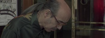 Movie still from “Post Mortem” (2010), directed by Pablo Larraín – An older man with a beard and glasses; Close Up shot, Low angle