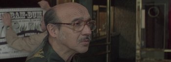Movie still from “Post Mortem” (2010), directed by Pablo Larraín – An older man with a mustache wearing glasses; Close Up shot, Over the shoulder angle