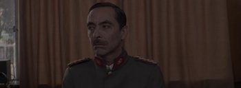 Movie still from “Post Mortem” (2010), directed by Pablo Larraín – A person wearing a military uniform; Close Up shot, Low angle