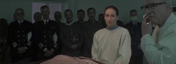 Movie still from “Post Mortem” (2010), directed by Pablo Larraín – A group of men in uniform standing next to each other; Medium shot, Over the shoulder angle