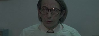 Movie still from “Post Mortem” (2010), directed by Pablo Larraín – An older man wearing glasses and wearing a white shirt; Close Up shot, High angle