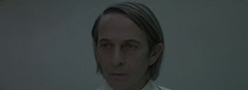 Movie still from “Post Mortem” (2010), directed by Pablo Larraín – A person with long hair; Close Up shot, Low angle